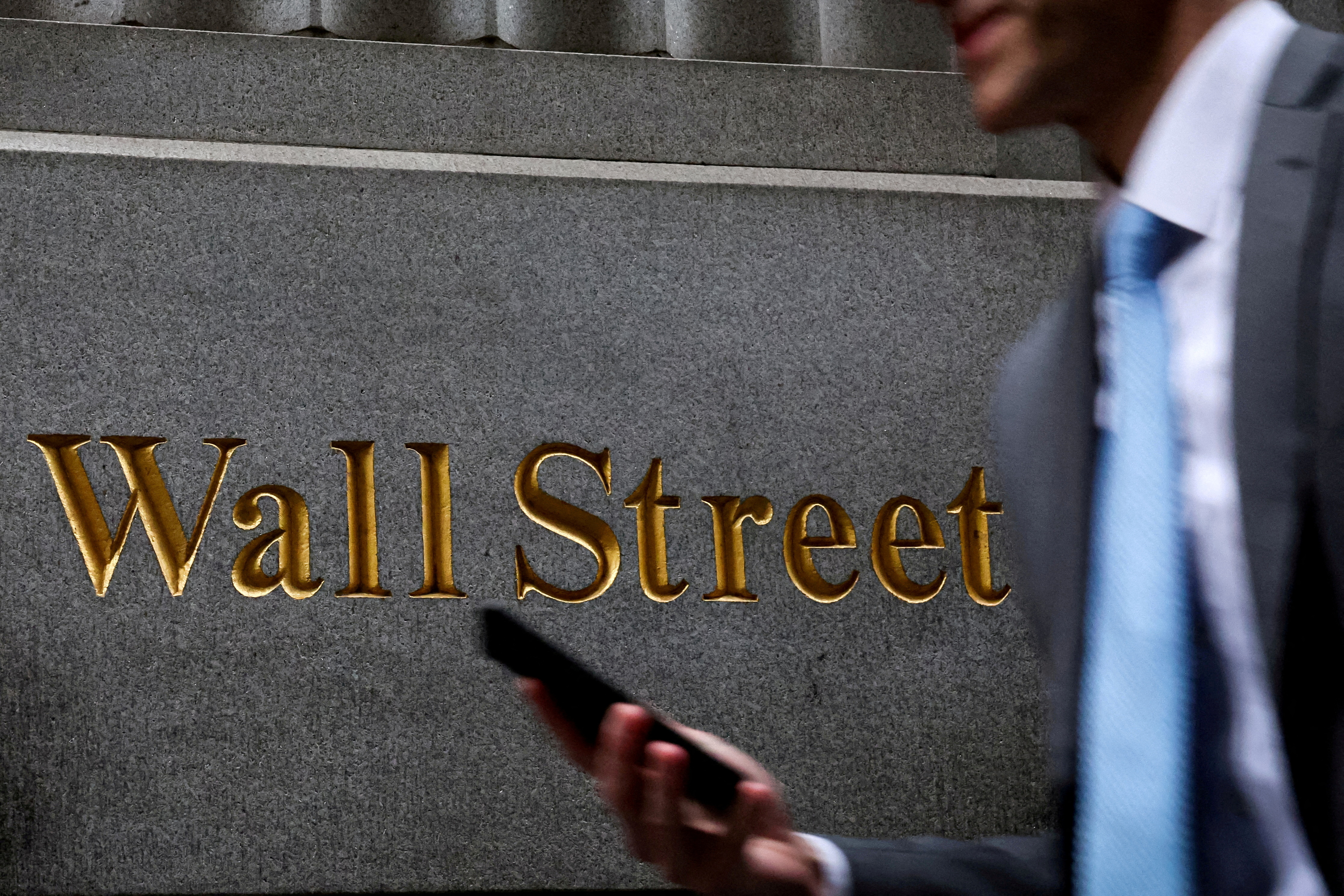 A man walks on Wall St. outside the NYSE in New York